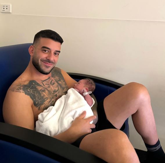 Adrian Portelli with his child